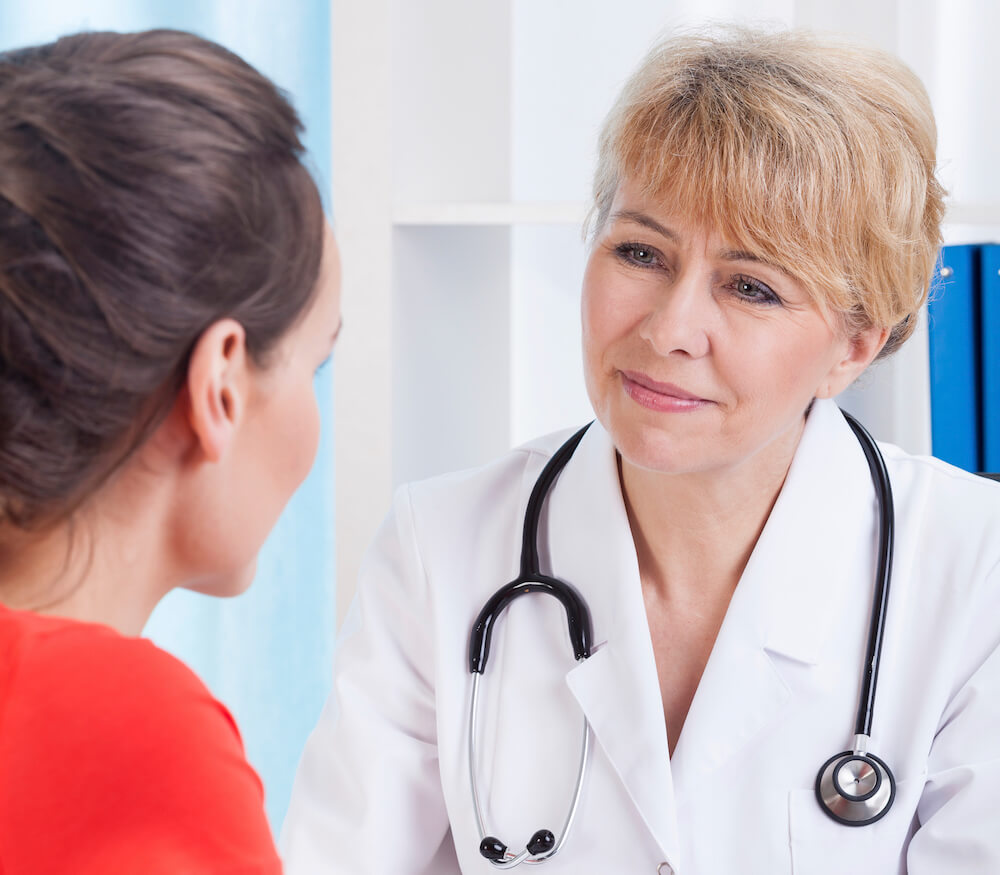 Female patient and a doctor in office